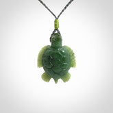 British Columbian jade turtle pendant. Hand carved jade turtle pendant, made by NZ Pacific for sale online. Unique handmade jewellery. Provided with an adjustable cord and packaged in a woven kete pouch.