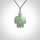 New Zealand jade turtle pendant. Hand carved jade turtle pendant, made by NZ Pacific for sale online. Unique handmade jewellery. Provided with an adjustable cord and packaged in a woven kete pouch.