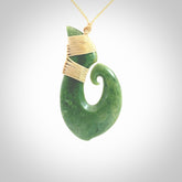 This picture shows a hand carved jade koru pendant. It is a deep green colour and is a wonderful, large sized piece of jewellery. The cord is a four plait beige colour and adjustable so that you can position the pendant where it suits you best. This koru was carved for us by Ric Moor. Delivery is free worldwide.