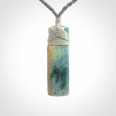 This is a hand carved toki pendant. Graeme carved this from Guatemalan Jadeite. It is a gorgeous blue colour and is an artistic piece of jewellery. Hand made by Graeme Wylie and delivered to you in a kete pouch.