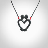Hand carved Black Jade couples kissing in the shape of a heart pendant. Contemporary design is black jade. Pendants for lovers. Provided with adjustable cord.