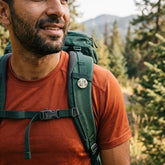 Man wearing bone pin on his backpack