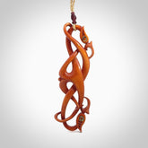 This necklace is carved from cow bone and stained with a homemade tea dye. It is a unique piece of wearable art that is sure to catch the eye. The shape is a complex twist form and has been beautifully hand carved by bone carver Yuri Terenyi.