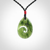 Hand carved New Zealand jade koru drop pendant. Made by NZ Pacific.Hand carved New Zealand jade koru drop pendant. Made by NZ Pacific.