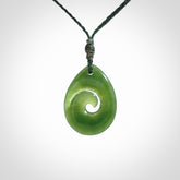 Hand carved New Zealand jade koru drop pendant. Made by NZ Pacific.Hand carved New Zealand jade koru drop pendant. Made by NZ Pacific.