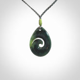 Hand carved New Zealand jade koru drop pendant. Made by NZ Pacific.Hand carved New Zealand jade koru drop pendant. Made by NZ Pacific.
