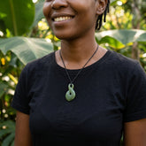 Woman wearing Hand carved New Zealand Jade twist pendant