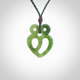 This is a handcarved love heart pendant made from a gorgeous and striking piece of British Columbia Jade stone. This is a superbly carved and very unique piece if custom jewellery. For sale online from NZ Pacific.