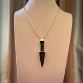A striking hand carved dagger pendant. These are carved with a Red Jasper Stone head and a hardwood handle. It is provided with a Sterling Silver chain. We ship these worldwide with express courier.