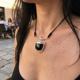 Woman wearing black jade and silver drop pendant