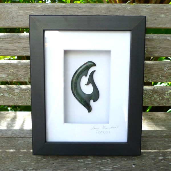 A hand carved large New Zealand Jade Koru necklace that has been framed and signed by artist Kerry Thompson. A large sized hand made koru necklace by New Zealand artist Kerry Thompson. One off framed work of art to wear. Delivered with Express Courier.