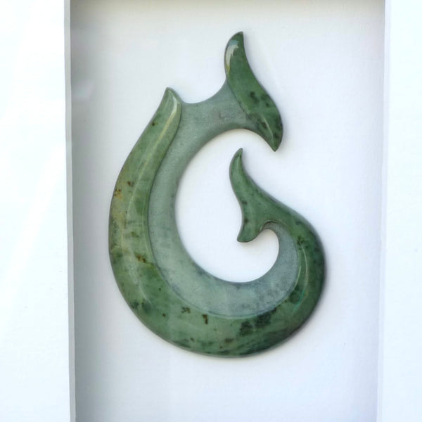 A hand carved large New Zealand Jade Hook, Matau, necklace that has been framed and signed by artist Kerry Thompson. A large sized hand made hook necklace by New Zealand artist Kerry Thompson. One off framed work of art to wear. Delivered with Express Courier.