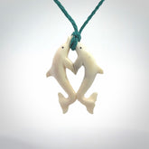 Hand carved natural double dolphin bone pendant. Hand made bone dolphin necklace, delivered with Express Courier. Hand crafted bone double dolphin pendant. Provided with an adjustable blue cord.
