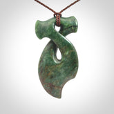 This hammerhead twist pendant is carved from a very striking New Zealand jade