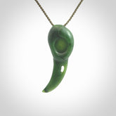 Hand carved huia bird skull made from New Zealand Marsden Jade pendant. Carved for NZ Pacific by Kyohei Noguchi. This is a contemporary piece of jewellery that is carved with intricate detail and clearly shows a beautiful bird skull. We ship this free worldwide with Express Courier.