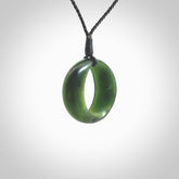 This little piece is a hand carved contemporary möbius ribbon disc pendant. Hand carved from New Zealand Kawakawa Jade. It has very subtle colour variations in the stone and is a delightful, small and artistic piece of jewellery. Hand made by Kyohei Noguchi and delivered to you in a kete pouch.