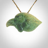 This picture shows a flower jade birds head. The bird is an extinct kokako - a saddleback that used to line in New Zealand's South Island. The cord is plaited and length adjustable. It is in two colours - khaki and burnt gold. We ship this worldwide.
