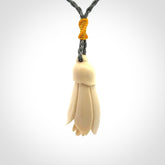 Hand carved Kowhai flower. These are made from Woolly Mammoth tusk and are a soft golden colour. They are provided with a hand plaited, adjustable cord. Shipping is free worldwide.