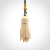 Hand carved Kowhai flower. These are made from Woolly Mammoth tusk and are a soft golden colour. They are provided with a hand plaited, adjustable cord. Shipping is free worldwide.