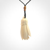 Hand carved Kowhai flower. These are made from Woolly Mammoth tusk and are a soft golden brown colour. They are provided with a hand plaited, adjustable cord. Shipping is free worldwide.