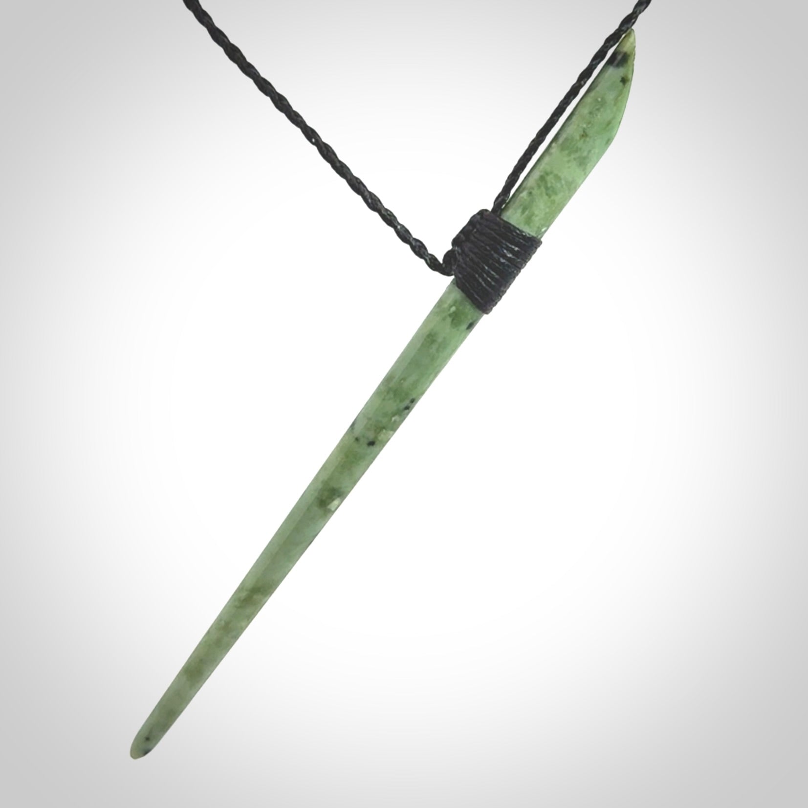 A hand carved New Zealand Jade pendant. The cord and binding is black coloured and is adjustable.