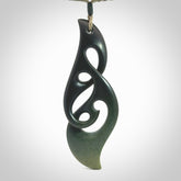 Hand carved New Zealand jade, complex twist drop pendant. Hand made complex twist pendant hand carved in New Zealand. Made by NZ Pacific, jade jewellery for sale online. One only hand made by Kerry Thompson.