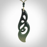 A hand carved twist pendant from New Zealand Jade. The cord is a khaki green colour and is adjustable.