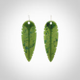 This picture shows British Columbian jade kaka feather earrings with sterling silver hooks. Hand made unique and contemporary feather earrings by Kerry Thompson. Hand carved here in New Zealand from British Columbian Jade. One pair only.