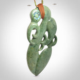 This picture shows a large traditional manaia pendant carved in New Zealand Jade.