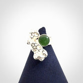 This is a handcrafted New Zealand Pounamu, Jade and sterling silver ring.