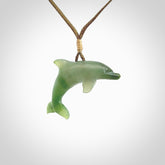 This is a gorgeous little dolphin pendant carved in green nephrite jade. The cord is fine and length adjustable so you can position the little jade dolphin where it suits you best. Shipping is free worldwide.