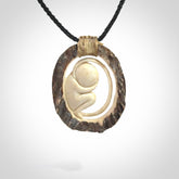 Hand carved deer antler fetus pendant. Hand carved by NZ Pacific. Free postage worldwide. Hand made fetus necklace from deer antler. Fetus necklace for men and women. Delivered with adjustable and packaged in a woven kete pouch.