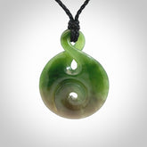 Hand carved New Zealand Jade Twist with Koru heart pendant. Unique Jade jewellery online for sale. Hand made Jade Twist with Koru, provided on adjustable cords and packaged in a woven kete pouch.
