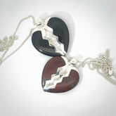 This is a hand carved love heart pendant made from your choice of either Black Jade or Red Jasper Stone with sterling silver. This is a superbly carved and very unique piece if custom jewellery. For sale online from NZ Pacific.