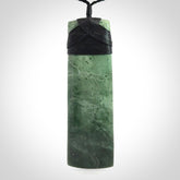 A large and beautiful hand carved toki pendant. This piece is carved from New Zealand jade by NZ Pacific. This is a wonderful large toki bound with a hand-plaited black cord and a traditional black lashing. A beautiful, traditional toki for sale online.
