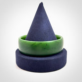 Hand carved jade bangle. Carved from green New Zealand jade. This is a solid jade bangle carved from a single piece of jade. It is polished to a sleek matte. the jade is otherwise untreated and completely natural.