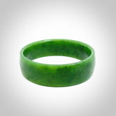 Hand carved jade bangle. Carved from green New Zealand jade. This is a solid jade bangle carved from a single piece of jade. It is polished to a sleek matte. the jade is otherwise untreated and completely natural.