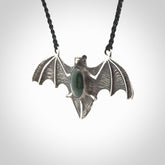 This is a hand carved bat pendant. It is made from New Zealand Jade and Sterling Silver. This is a medium sized necklace and is a very unique, one only, pendant that is a collectors piece. Provided with black adjustable cord.
