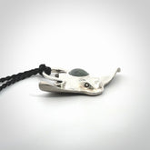 This is a hand carved Sterling Silver Eagle Ray pendant with New Zealand Jade insert. This is a medium sized necklace and is provided with an adjustable black cord.