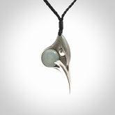 This is a hand carved Sterling Silver Huia bird pendant with Siberian Jade insert. This is a medium sized necklace and is provided with an adjustable black cord.