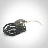 This is a hand carved Sterling Silver Huia bird pendant with New Zealand Jade insert. This is a large sized necklace and is provided with an adjustable black cord.