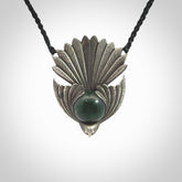 This is a hand carved Sterling Silver Fern fantail pendant with New Zealand Jade insert. This is a medium sized necklace and is provided with an adjustable black cord.