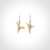 Hand carved small sized mako shark tooth earrings. Hand made shark tooth earrings. Real shark tooth art to wear. Free Shipping worldwide. Packaged in a woven kete pouch.