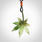 Cannabis Leaf Jade Stone pendant. Handmade jade Cannabis flower jewellery made by NZ Pacific and for sale online. Jade stone Marijuana leaf pendant for men and women. Unique art to wear from NZ Pacific. Delivered on an adjustable cord.