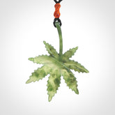 Cannabis Leaf Jade Stone pendant. Handmade jade Cannabis flower jewellery made by NZ Pacific and for sale online. Jade stone Marijuana leaf pendant for men and women. Unique art to wear from NZ Pacific. Delivered on an adjustable cord.
