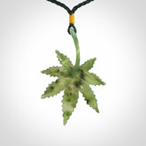 Cannabis Leaf Jade Stone pendant. Handmade jade Cannabis flower jewellery made by NZ Pacific and for sale online. Jade stone Marijuana leaf pendant for men and women. Unique art to wear from NZ Pacific. Delivered on an adjustable cord.