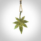 Cannabis Leaf Jade Stone pendant. Handmade jade Cannabis flower jewellery made by NZ Pacific and for sale online. Jade stone Marijuana leaf pendant for men and women. Unique art to wear from NZ Pacific. Delivered on an adjustable cord.