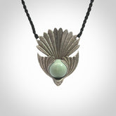 This is a hand carved Sterling Silver Fern fantail pendant with New Zealand Jade insert. This is a medium sized necklace and is provided with an adjustable black cord.