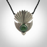 This is a hand carved Sterling Silver Fern fantail pendant with New Zealand Jade insert. This is a medium sized necklace and is provided with an adjustable black cord.