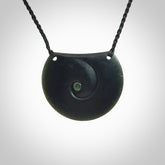 This is a hand carved Black Jade drop pendant with New Zealand Jade insert. This is a medium sized necklace and is provided with an adjustable black cord.